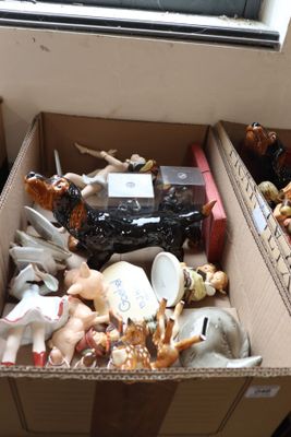 a box full of assorted figurines sitting on the floor
