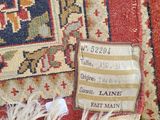 an image of a close up of a rug with a tag on it