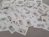 a pile of postcards sitting on top of a table