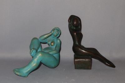 a statue of a woman sitting next to a statue of a man