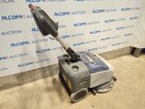 an image of a vacuum cleaner sitting on the floor in front of a wall