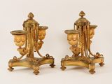 pair of antique brass and marble vases on stands on a white background