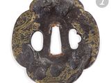 an old iron tsuba with two holes in the middle