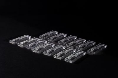 a close up of six clear plastic trays on a black surface