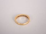 a close up of a gold ring on a white surface