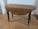 a small table with a wooden top sitting on the floor