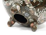 a decorative vase with a hole in it on a white surface