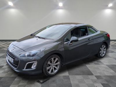 a picture of a grey car parked in a garage