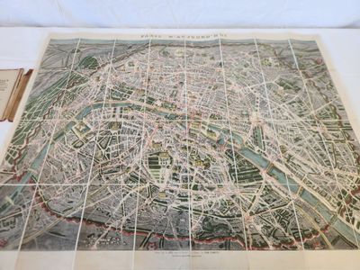 an old map of the city of paris on display on a table