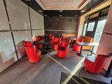 many red chairs and tables in a restaurant