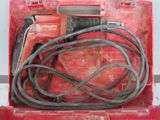 a red tool box with a cord and a drill in it