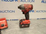 a close up of a cordless drill with a charger on a table