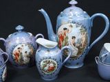 a blue and white tea set with a cup and saucer
