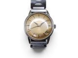 a close up of a watch on a white surface with a white background