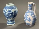 two blue and white vases sitting next to each other on a table