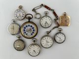 many different types of pocket watches displayed together