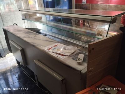 a counter that has a glass case on top of it
