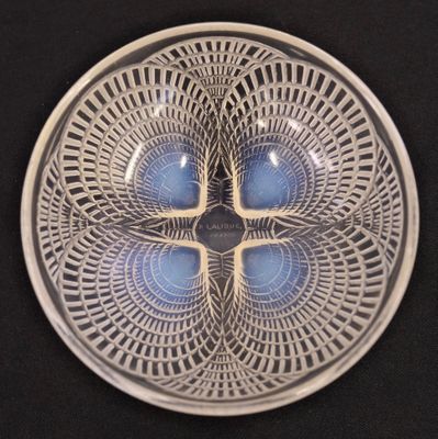 a glass plate with a design on it on a black surface