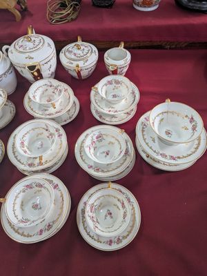 a table with a bunch of plates and cups on it