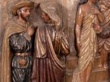 a statue of a man and a woman standing next to a statue of jesus