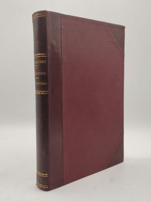 un vieux livre à la couverture rouge posé sur une table