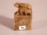 a small statue of a dog and a cat on a box
