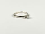 a close up of a silver ring with a diamond on it