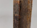 an old book sitting on top of a wooden table