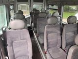 many seats in the back of a bus that are empty