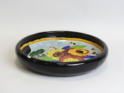 a black bowl with a colorful flower design on it