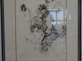 framed drawing of a woman sitting on a chair in a room