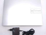 a white laptop with a charger and a power cord