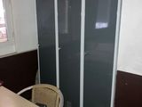 two lockers in a room with a table and chairs