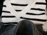 a sweater and sweaters that are sitting on a table