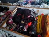 a wooden box filled with many different types of scarves