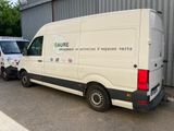 two vans that are parked in front of a building