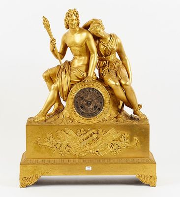 an image of a gold statue of a man and a woman holding a clock