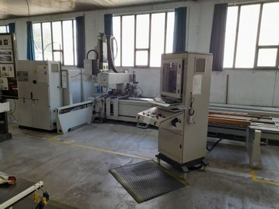 a machine that is working on a piece of wood in a factory