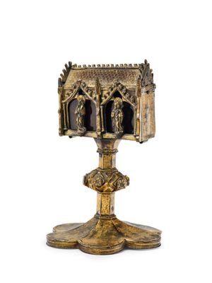 an image of a gold cup with a statue of a man and a woman on it