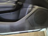 a close up of a car door with a speaker in it