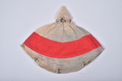an image of a red and beige striped bag hanging on a white wall