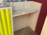 a desk with a yellow curtain on it in a room