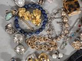 a pile of assorted jewelry on a table