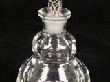 a close up of a clear glass bottle with a glass top