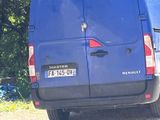 a blue van that is parked on the side of the road