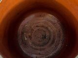 a close up of a brown vase with a white background