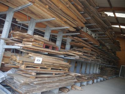 many stacks of wood in a warehouse with a price tag on them