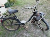 a old bike that is sitting in the grass