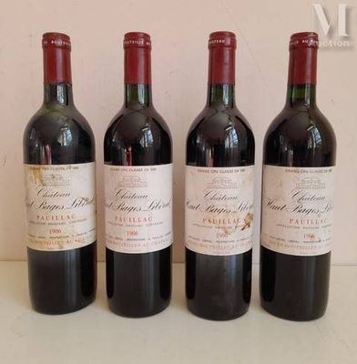 three bottles of red wine are lined up on a table