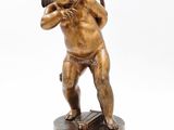 an antique bronze statue of a cupid holding a book on a wooden base